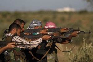 Syrian opposition fighters fire at targets